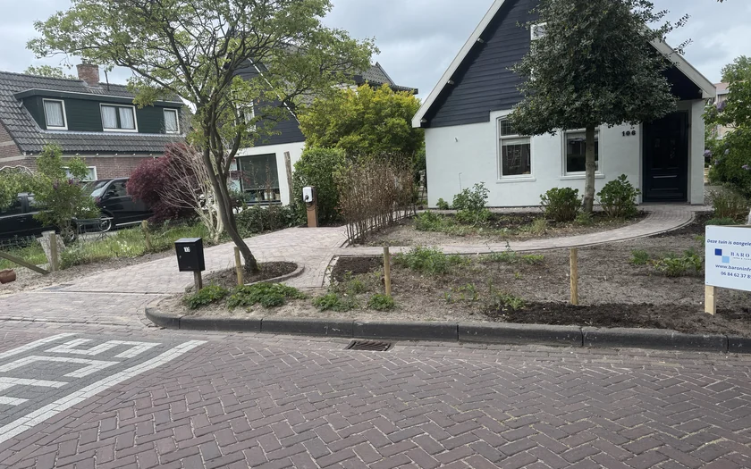 Oprit van gebakken klinkers die vanaf de straat naar een vrijstaande woning loopt